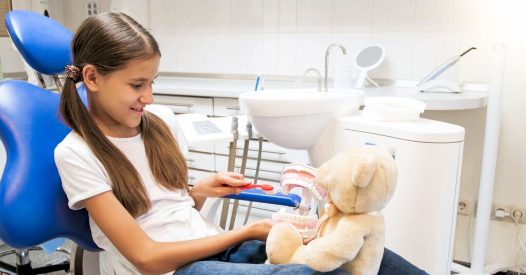 child at a dentist for teeth whitening